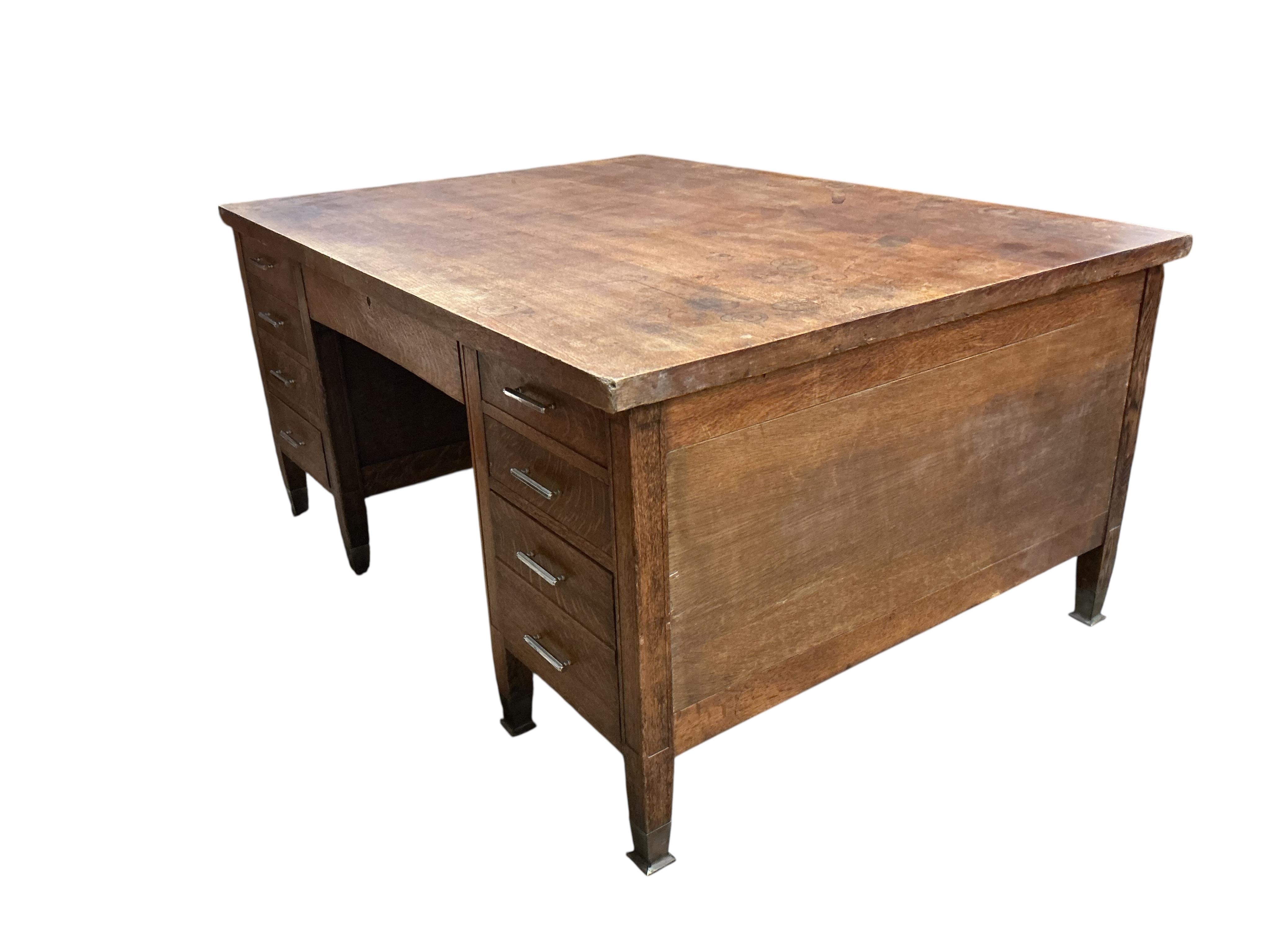 An early 20th century Continental oak kneehole partner's desk, width 168cm, depth 122cm, height 79cm